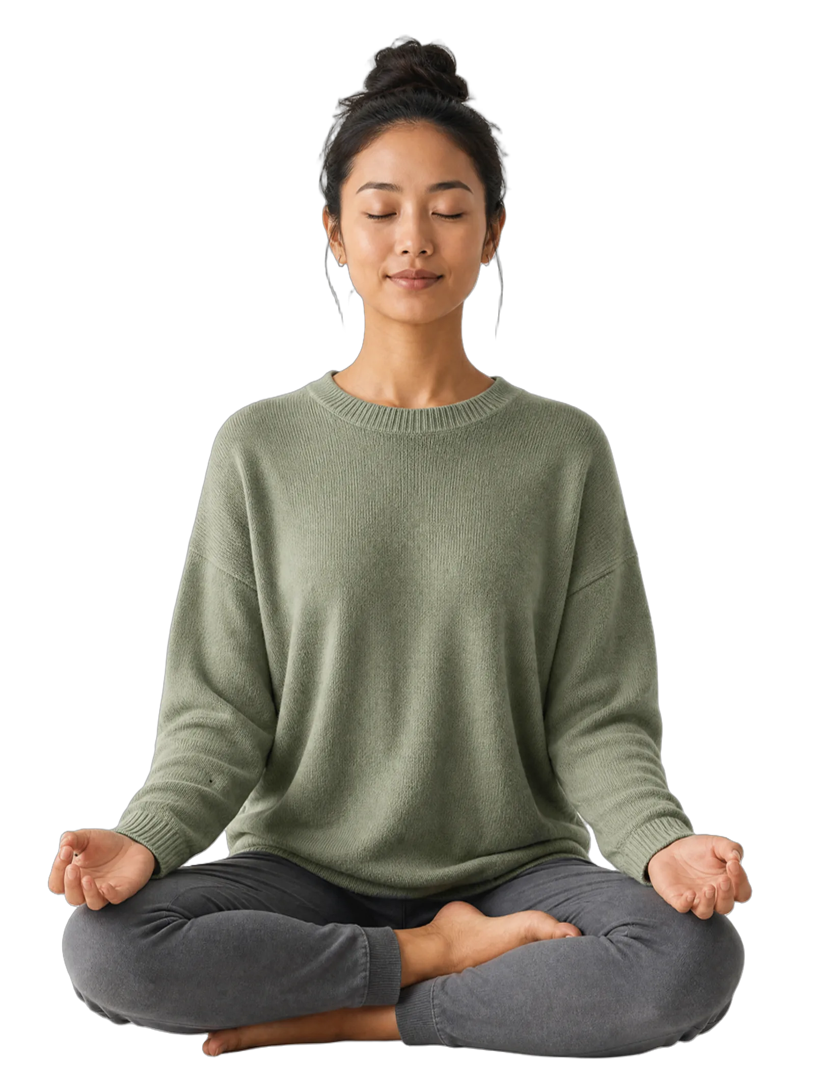 A person cropped from the shoulders to the mid-thigh, sitting cross-legged in a relaxed, upright posture with hands resting gently open on their knees, wearing a soft knit sweater.